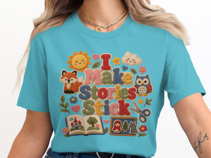T-shirt with "I Make Stories Stick" text and cute storybook illustrations.