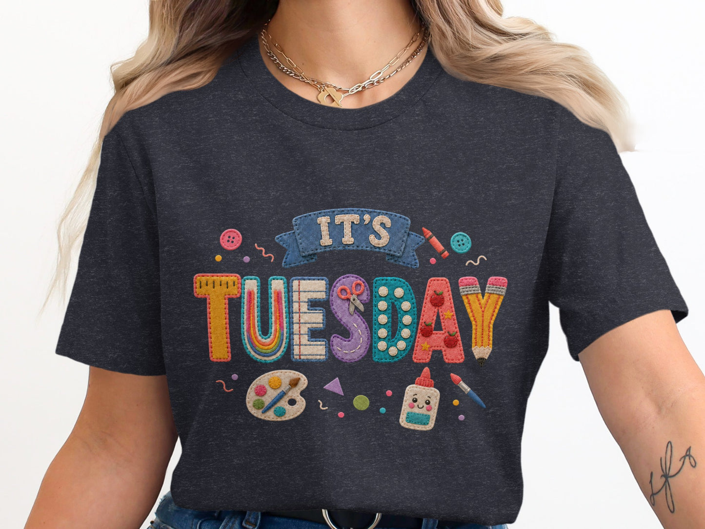 Dark t-shirt with "It's Tuesday" design featuring school supplies and buttons.