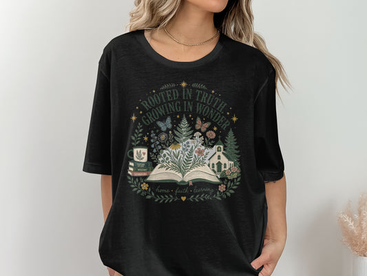 Black t-shirt with "ROOTED IN TRUTH, GROWING IN WONDER" and floral design.