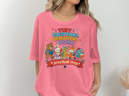 Pink t-shirt with "Tiny Questions Beautiful Work Preschool Crew" and cartoon animals.