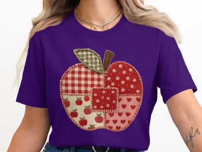 Purple t-shirt with a stitched apple graphic made of assorted fabric patterns.