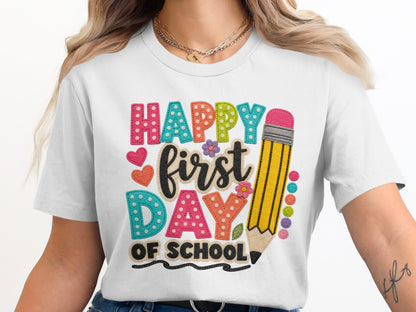 White t-shirt with "Happy First Day of School" text and pencil graphic.